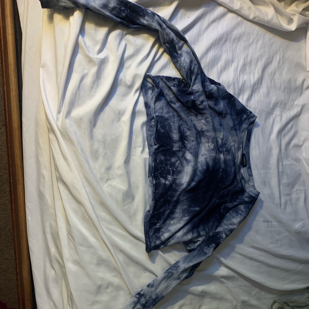 A dark and light blue tie-dye long sleeve crop top